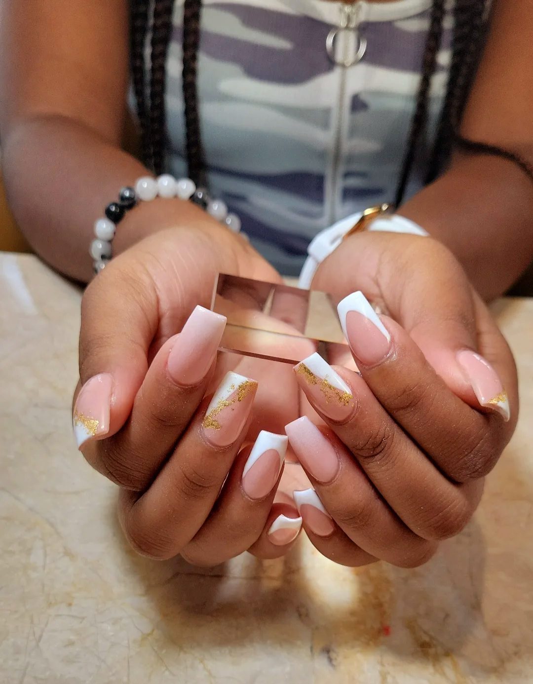Long white French tips with gold glitter accents