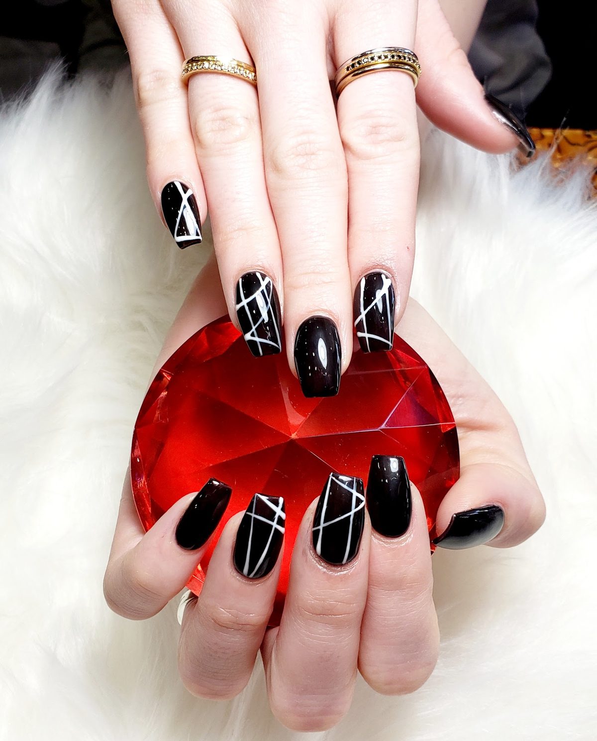 Glossy black square nails with white line art
