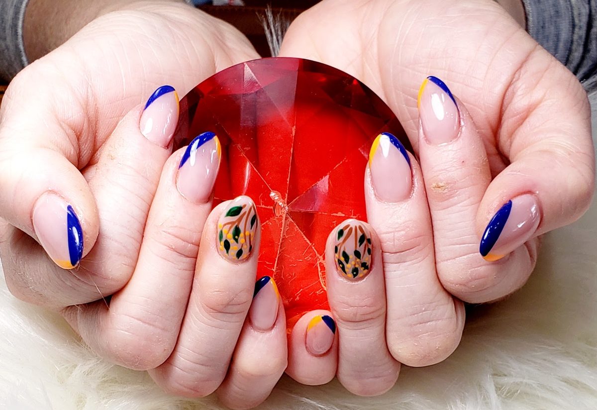 Blue French tips with orange and floral accents