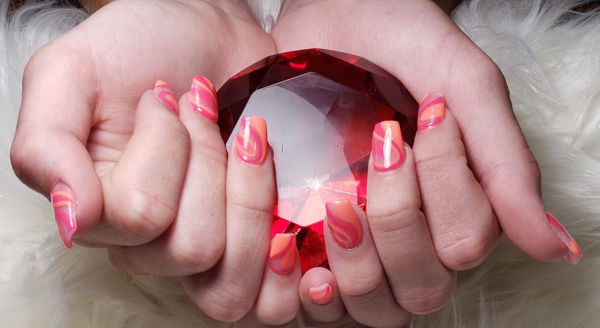 Coral and pink square nails with layered swirls