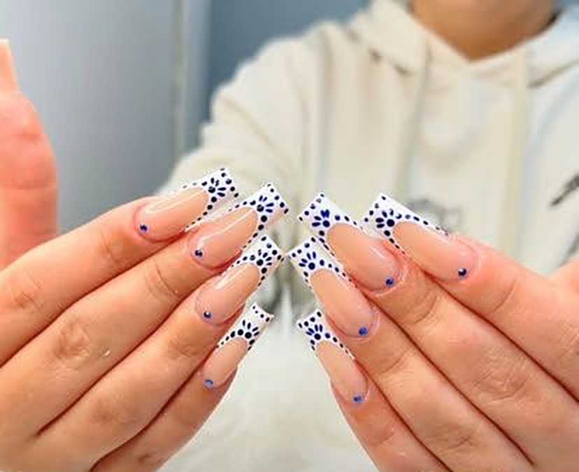 Long square nails with white tips and navy dotted flower detail — Dipping at Viva Nail Spa